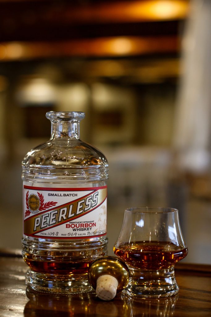 Bottle of Bourbon with a glass on a bar