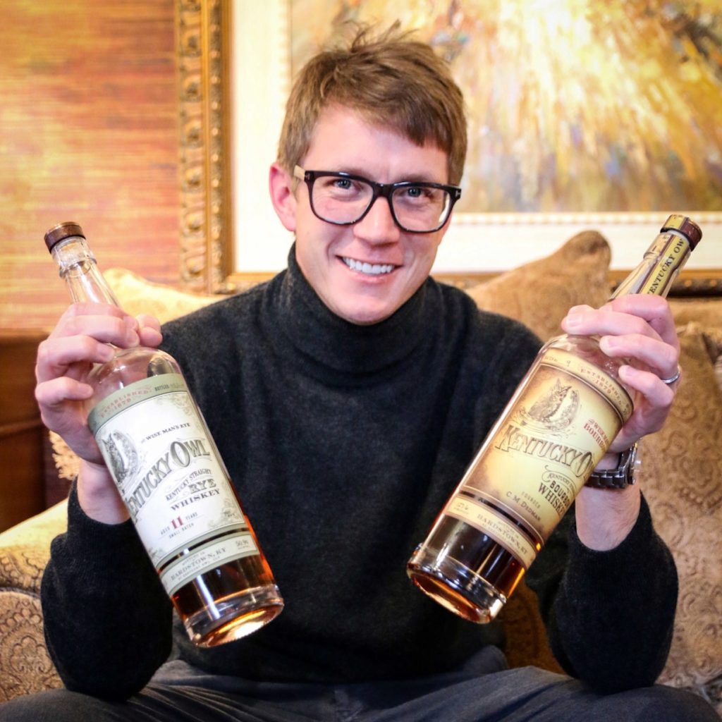 Man holding two bottles of Kentucky Owl