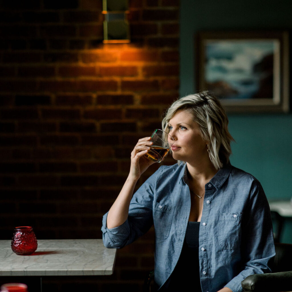 Marianne Eaves, female distiller, tasting whiskey