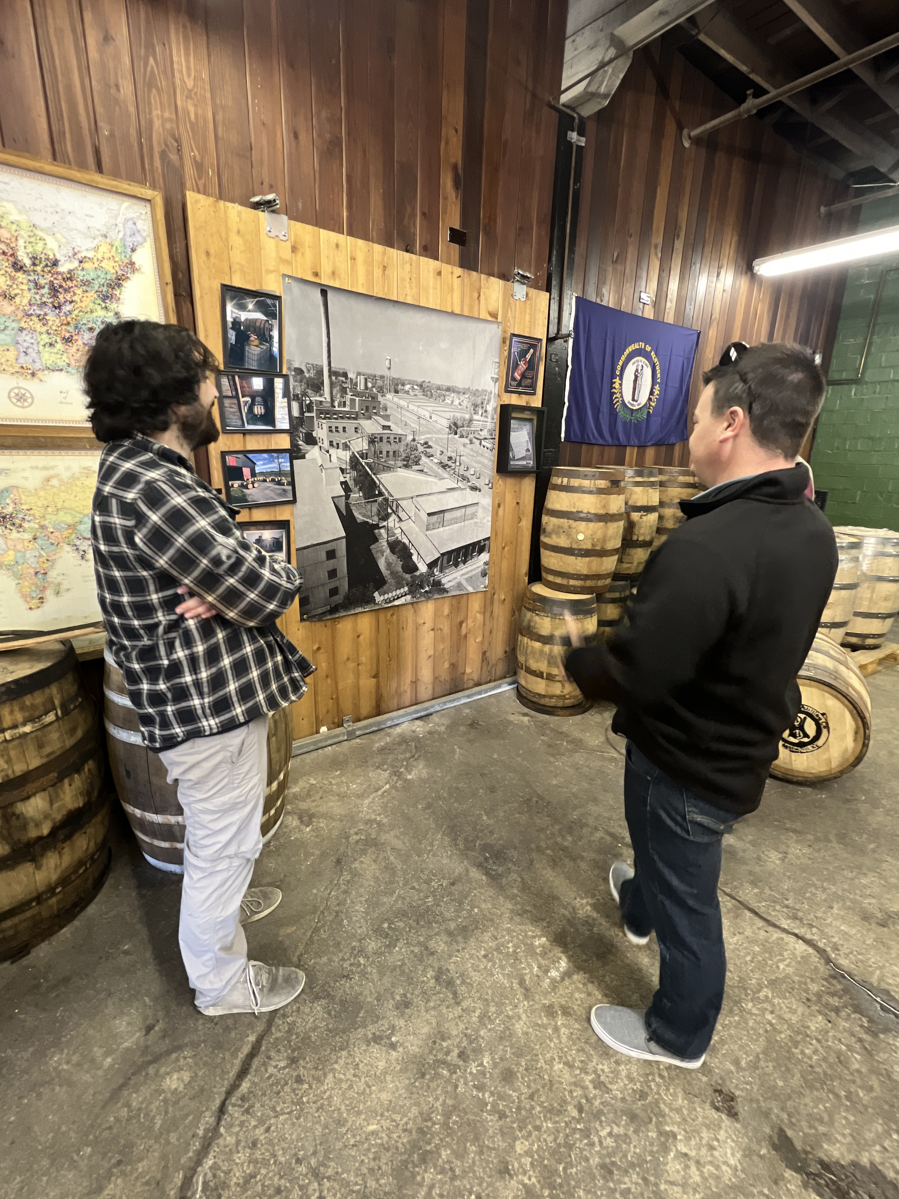 Two men standing and looking at a map
