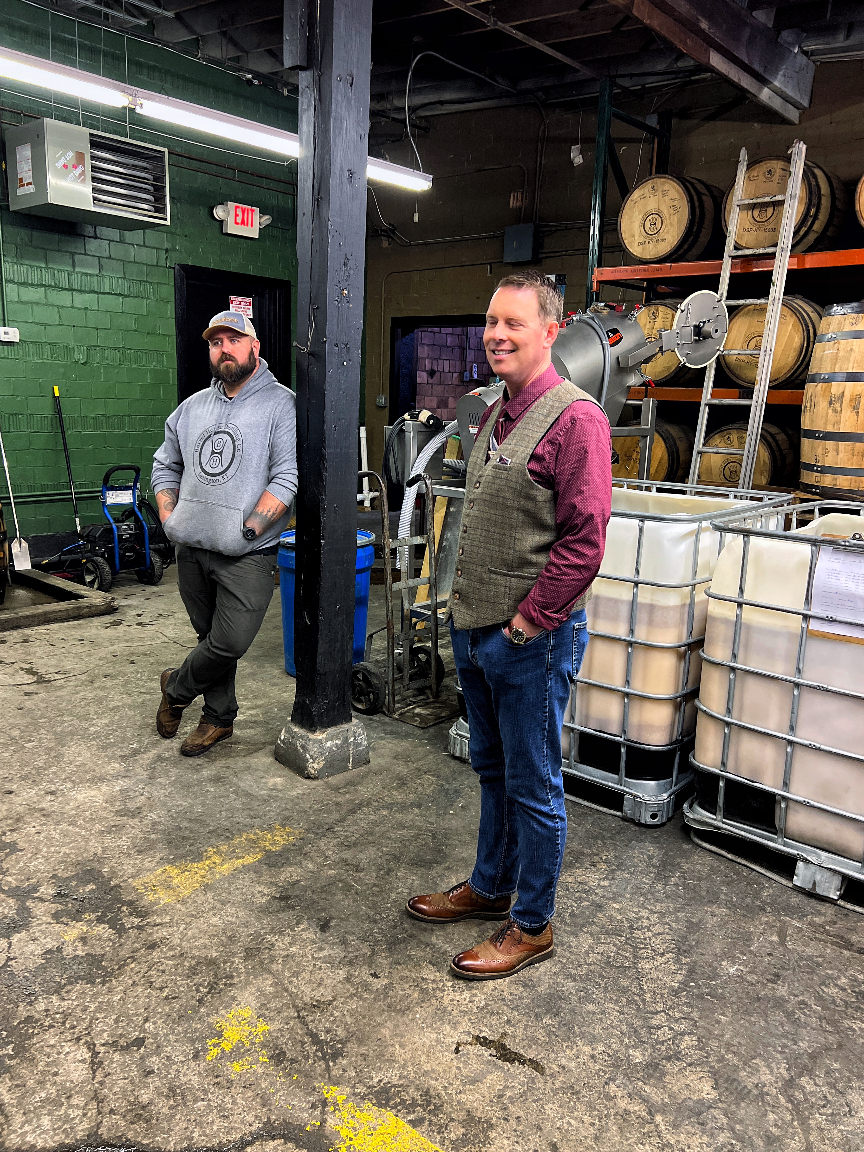 Two men standing in a warehouse