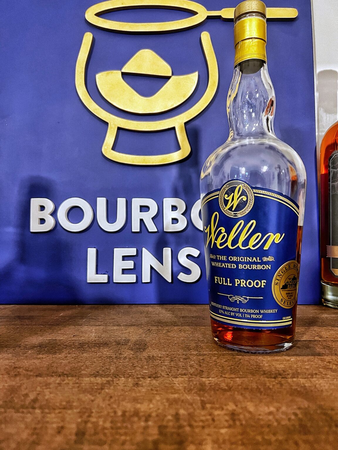 Weller Full Proof with Bourbon Lens Sign in the background