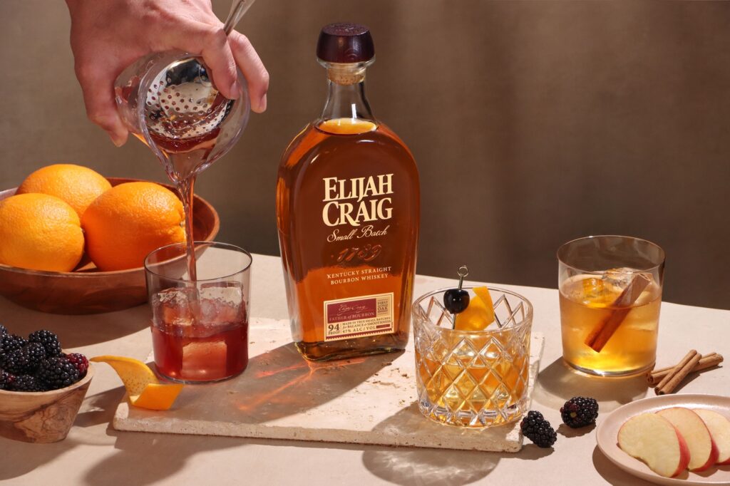 A table set up with cocktail ingredients to prepare an Elijah Craig bourbon Old Fashioned.