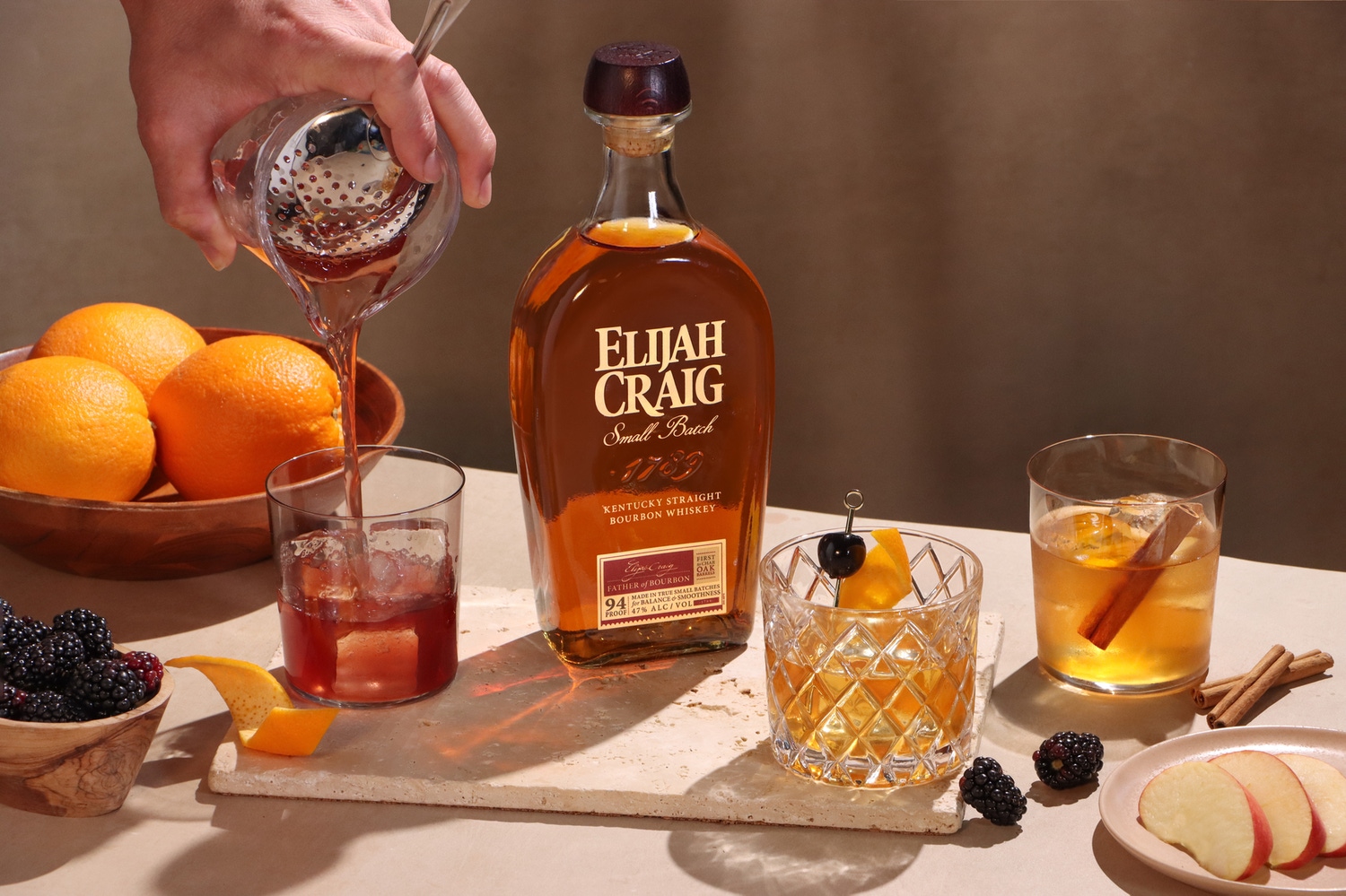 A table set up with cocktail ingredients to prepare an Elijah Craig bourbon Old Fashioned.