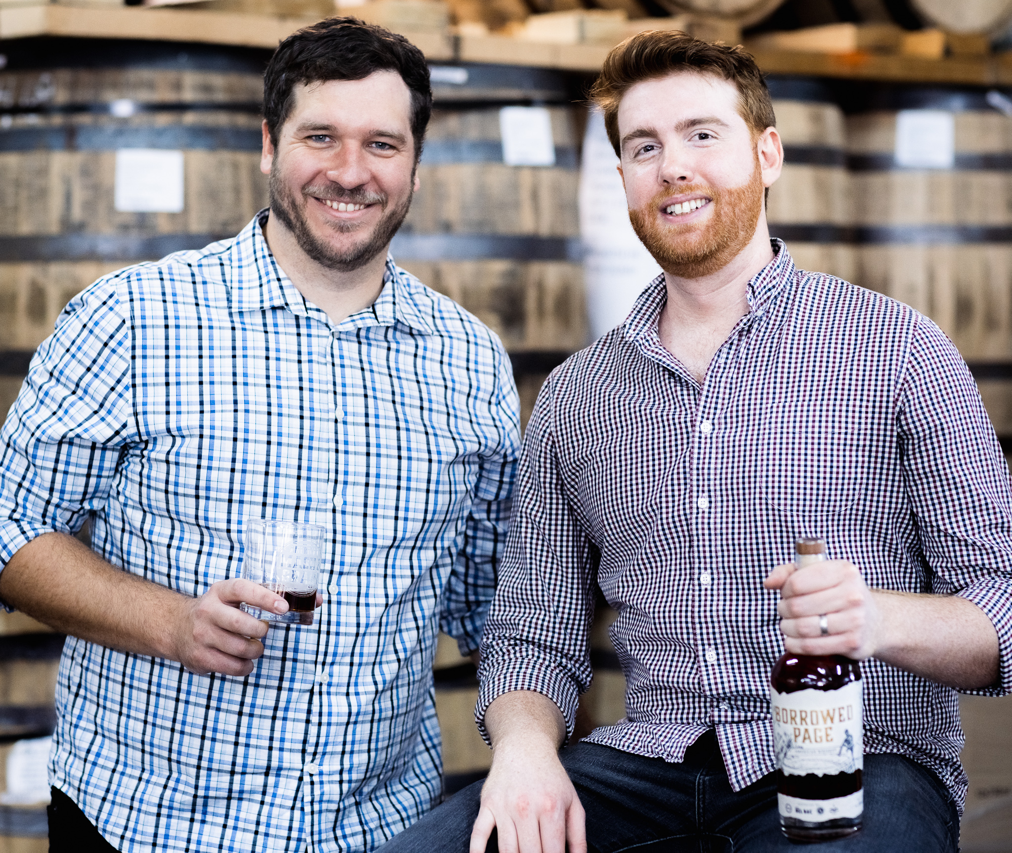 American Mash & Grain Founders Devin and Chase with a bottle of Borrowed Page.