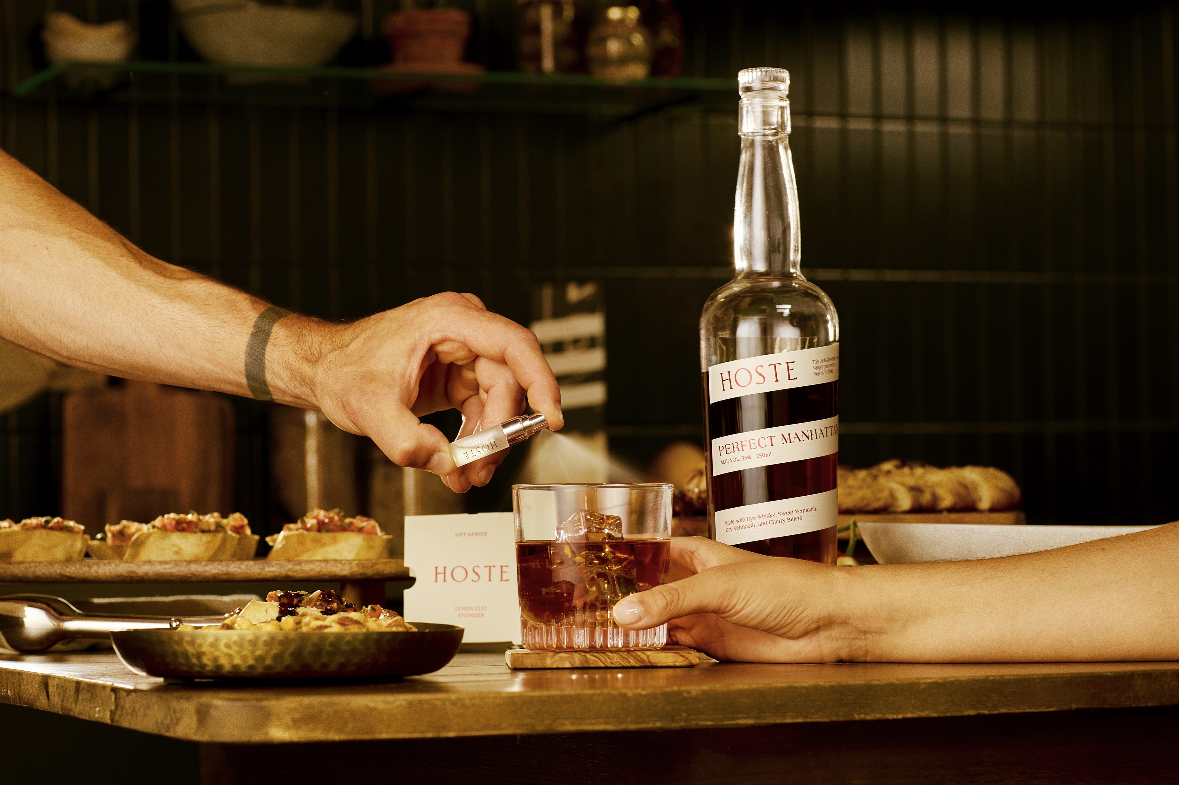 food and glass with a spray accenting the whiskey in the glass.