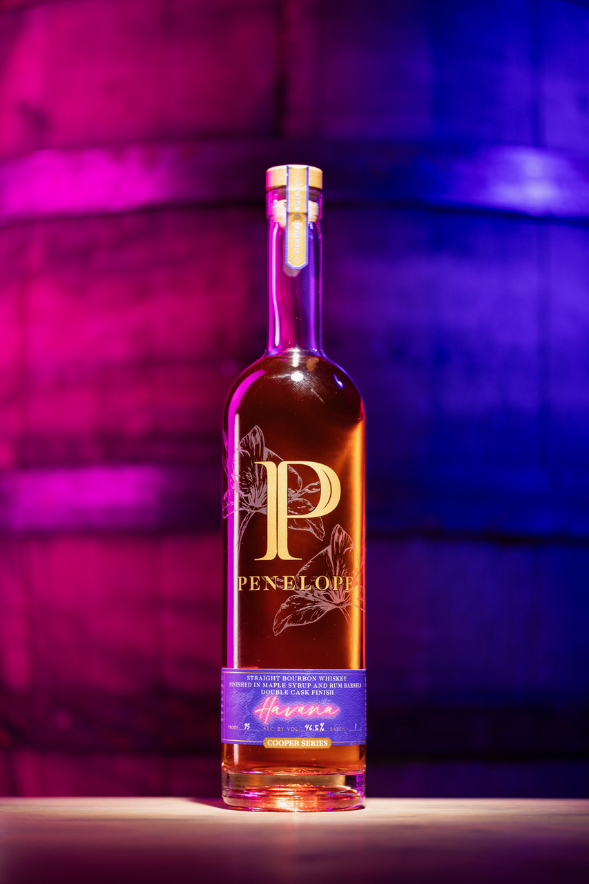 Bottle of Penelope Havana back lit with purple and blue