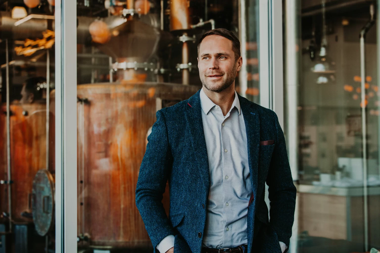 Dan Callaway, Master Blender at Lofted Spirits, with Bardstown Bourbon and Green River Whiskey bottles.