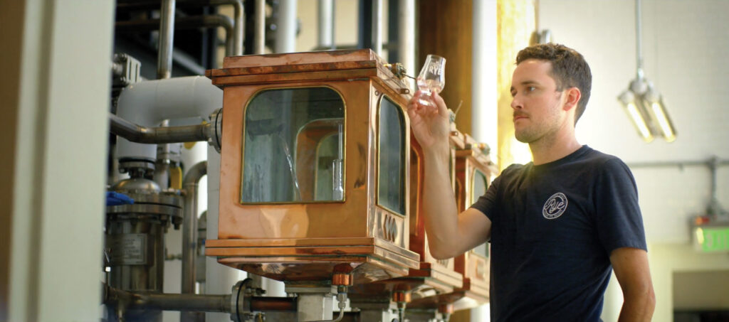 Ryan Norwood next to low wine and high wine.