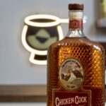 Chicken Cock Old Glory with Bourbon Lens Logo in the background.