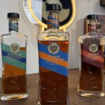 Rabbit Hole Distillery Exclusives Bottles With Bourbon Lens Logo in the background