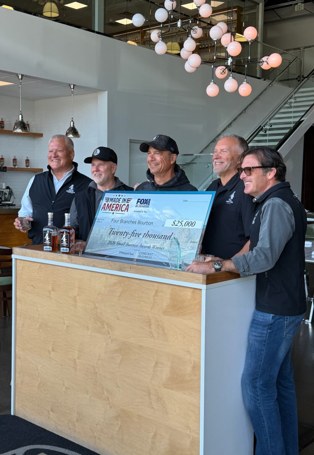 All the founders holding a large check